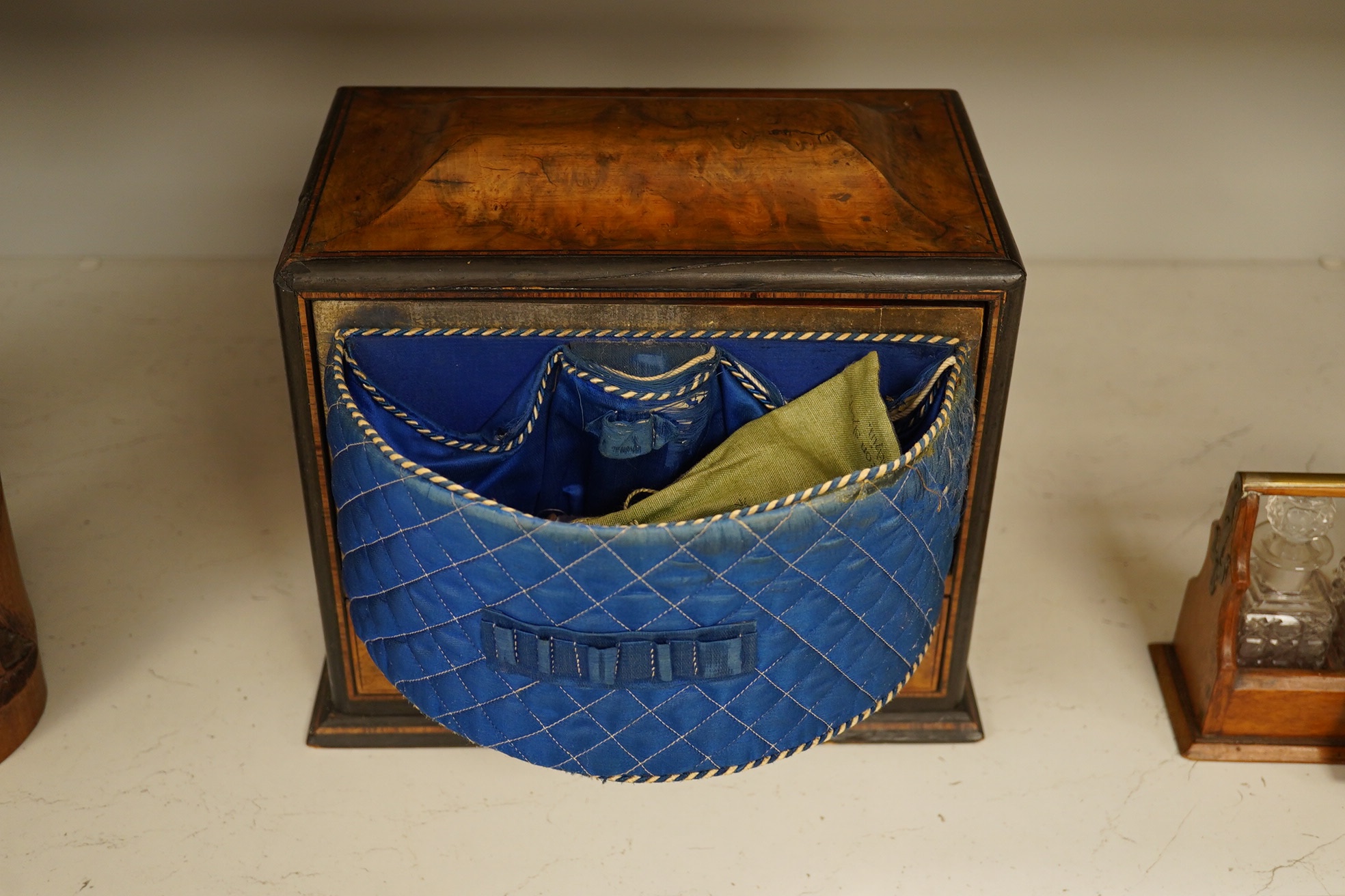 A Victorian burr walnut workbox, with blue silk semi-circular sewing drawer. 29cm wide, 26cm high. Condition - fair